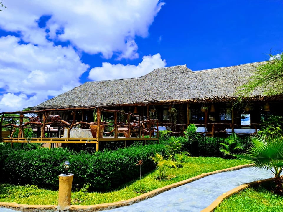The thatched lounge and dining terrace above the gardens